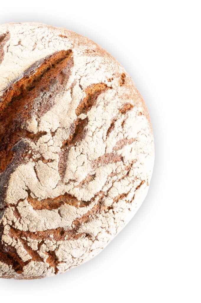 Halbes Hausbrot aus der Vogelperspektive auf weißem Hintergrund.